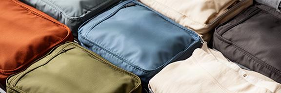 Geöffneter Koffer mit farblich sortierten Packwürfeln für Kleidung